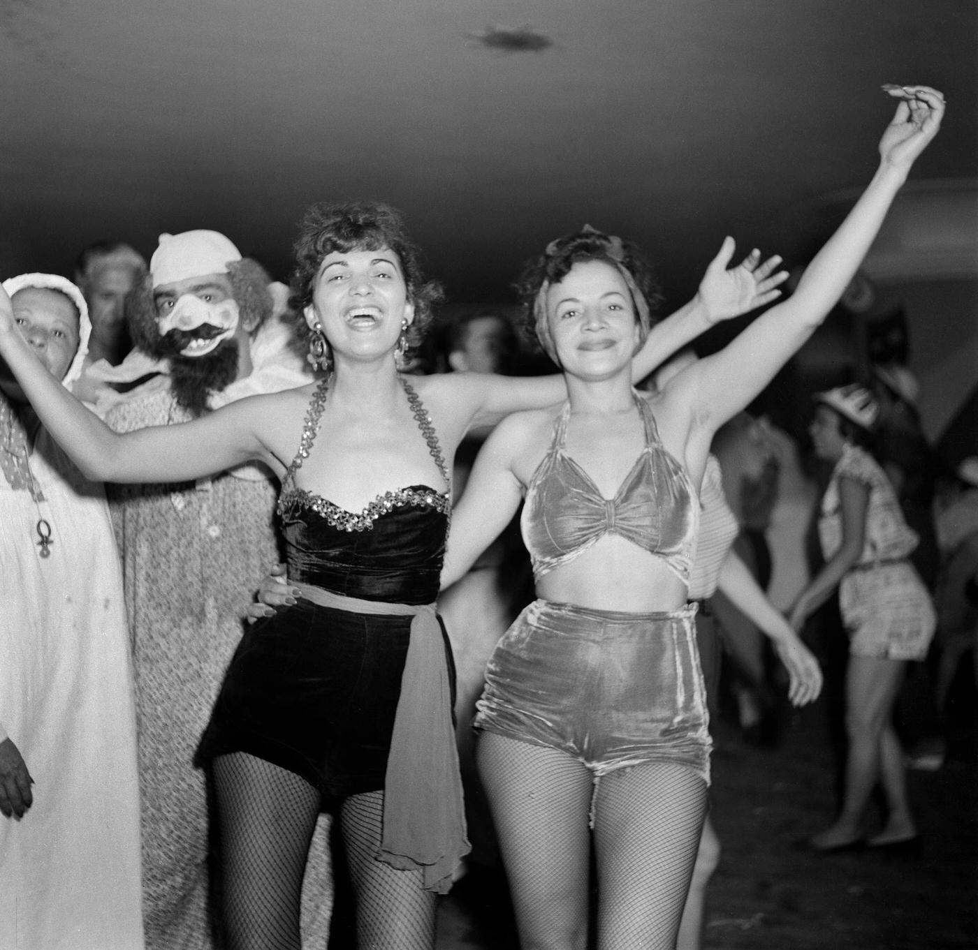 Carnival parade revelers pose at a party in Rio de Janeiro's Carnival. 1953