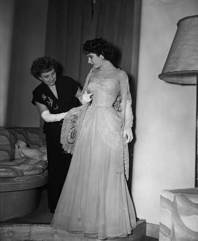 At the Savoy Hotel, Sara Sothern helps her daughter Elizabeth Taylor to dress for the Royal Command Film Performance, London, 29th November 1948. The screening will be at the Empire cinema, Leicester Square