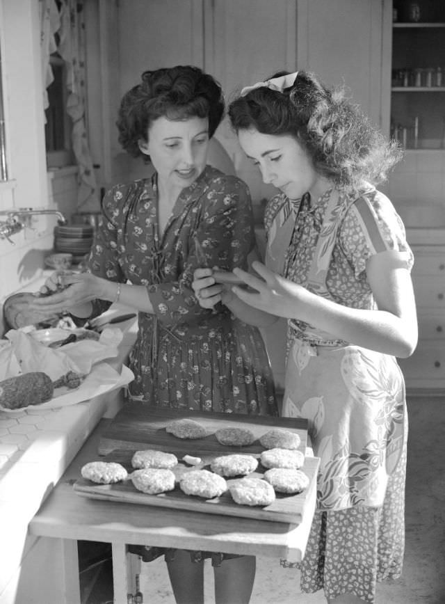 The family's Beverly Hills home was built in 1929 and had five bedrooms. Here, Elizabeth makes hamburgers in the home's kitchen with her mother, a stage mom who was very involved in her daughter's career, 1947