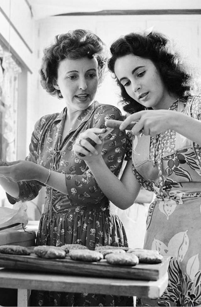 Elizabeth makes hamburgers in the home's kitchen with her mother, 1947
