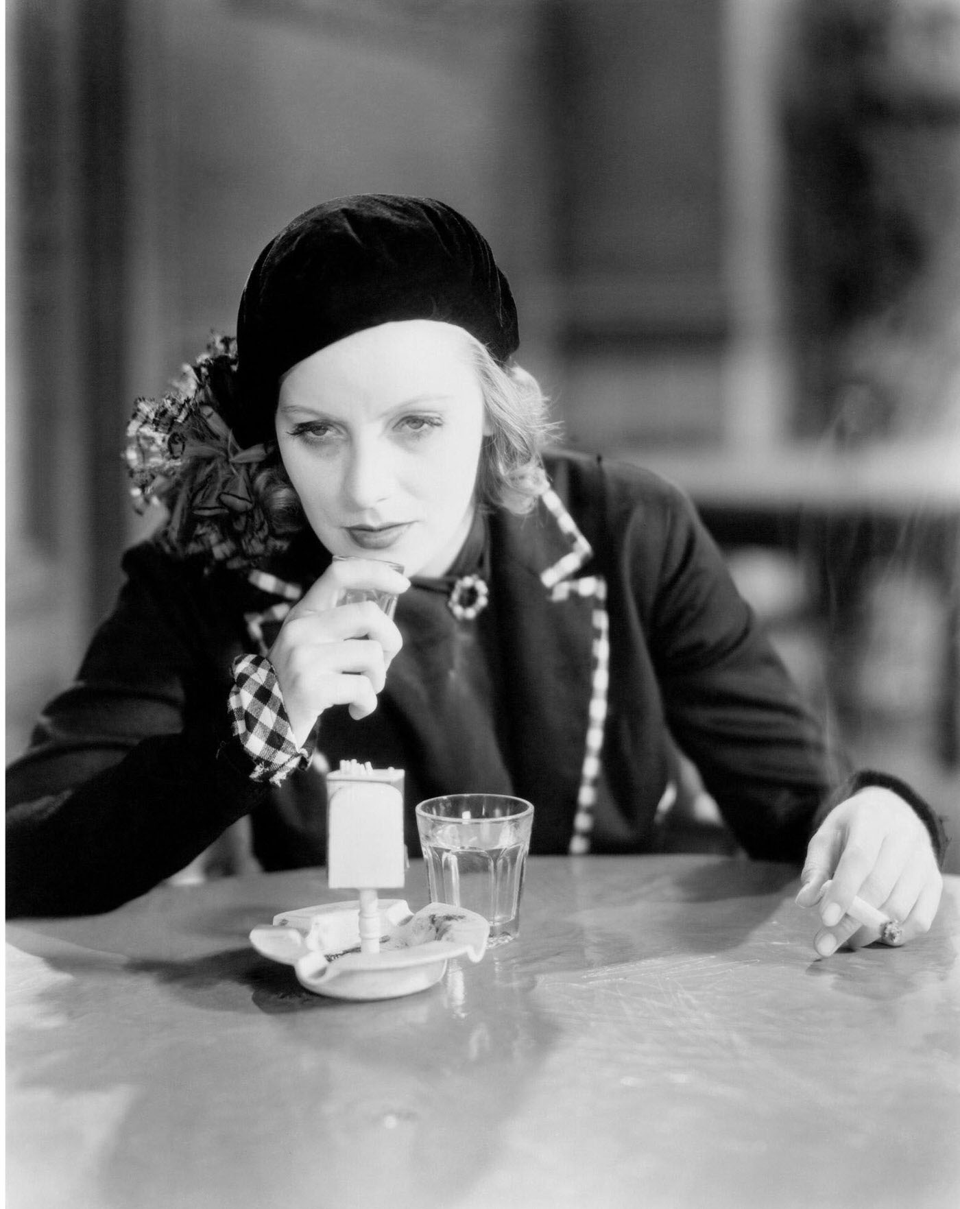 Swedish Actress Greta Garbo drinking whiskey and smoking a cigarette in 'Anna Christie', 1930, United States.