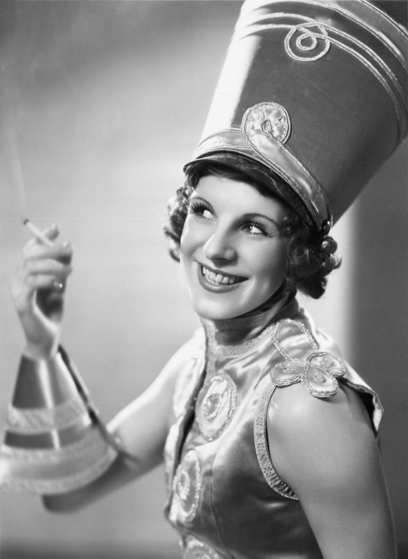 Dancer Iris Kirkwhite dressed as a soldier wearing a shako, 1933