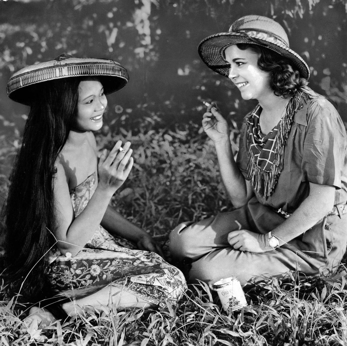 Osa Johnson smoking a cigarette with a woman in traditional clothing, 1937