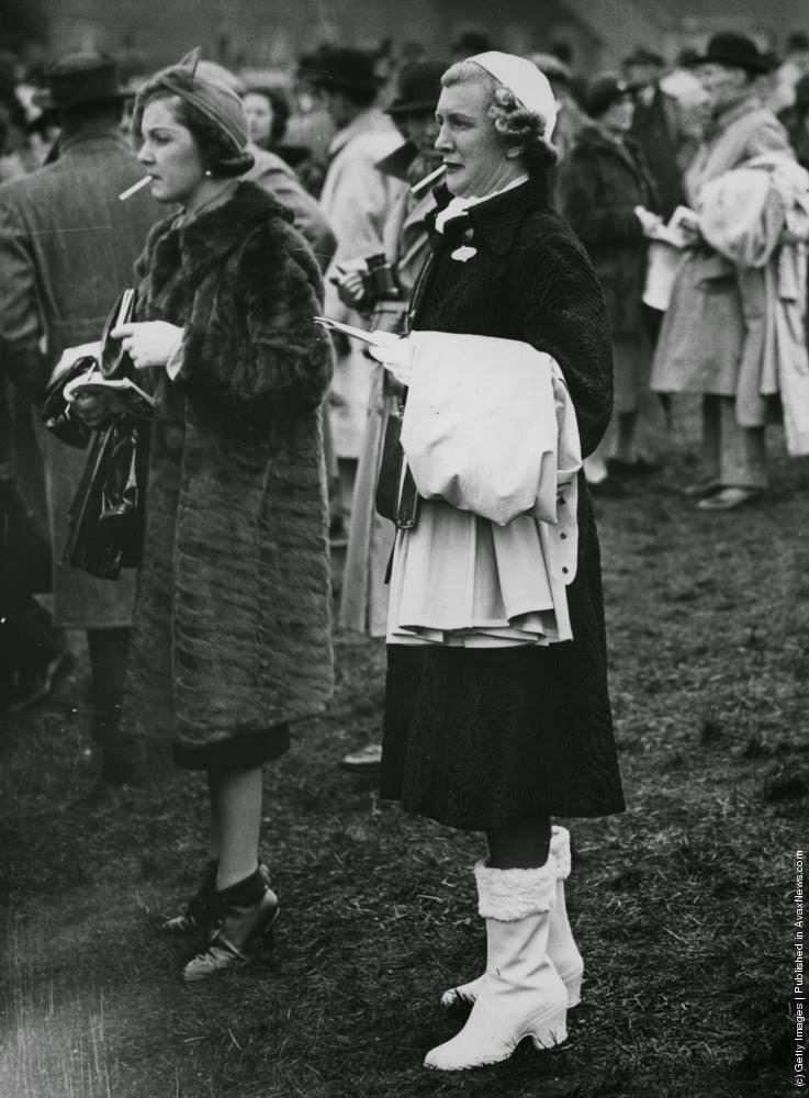 Two racegoers obviously need a cigarette to calm their nerves, 25th March 1938