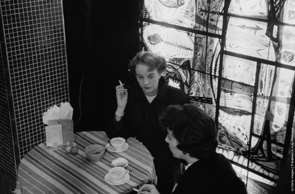 Two women chatting at a coffee bar in London. 4th November 1955.