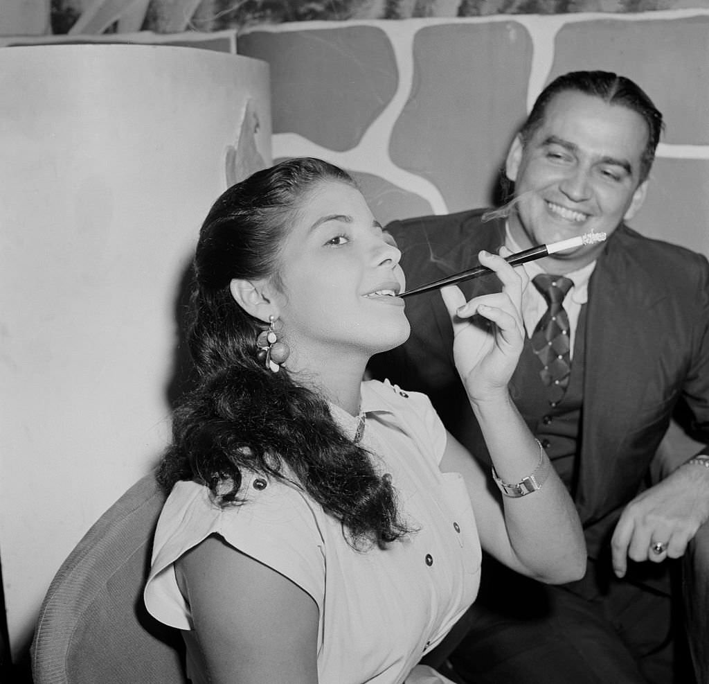 A woman smokes a cigarette in a local restaurant in Rio De Janeiro, Brazil, circa 1950.