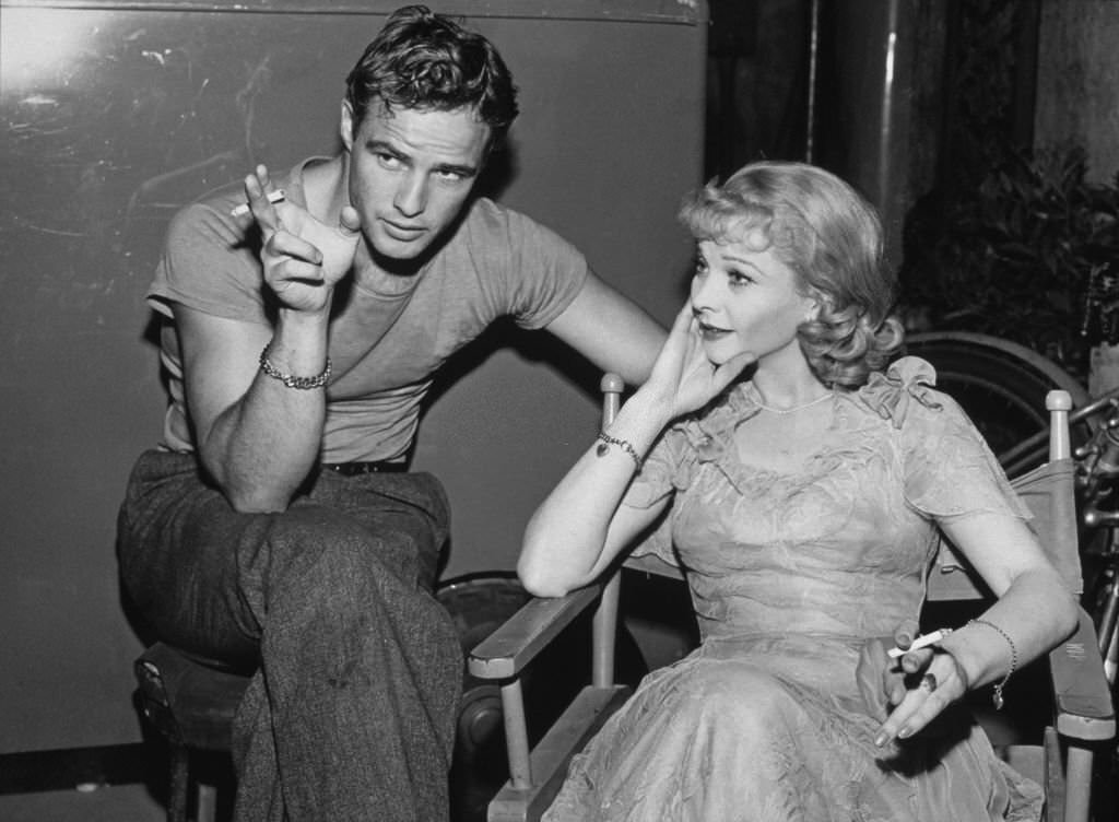 Marlon Brando and Vivien Leigh relax on the set of 'A Streetcar Named Desire,' without visible cigarettes, circa 1951.