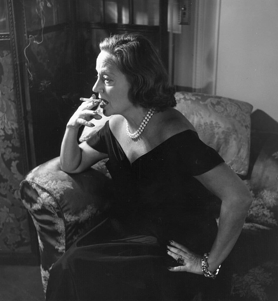 American theatrical leading lady Tallulah Bankhead smoking a cigarette in London at the Ritz, 1951.