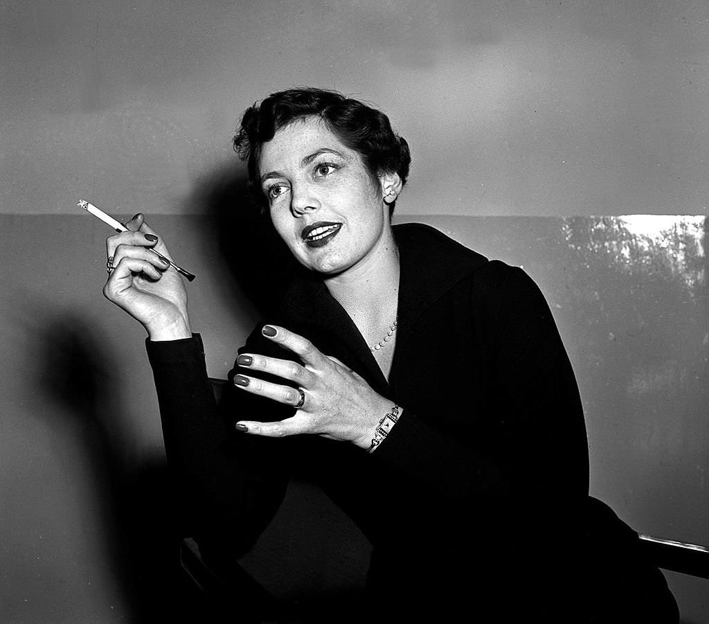Actress Diane Hart smoking a cigarette, 1952.