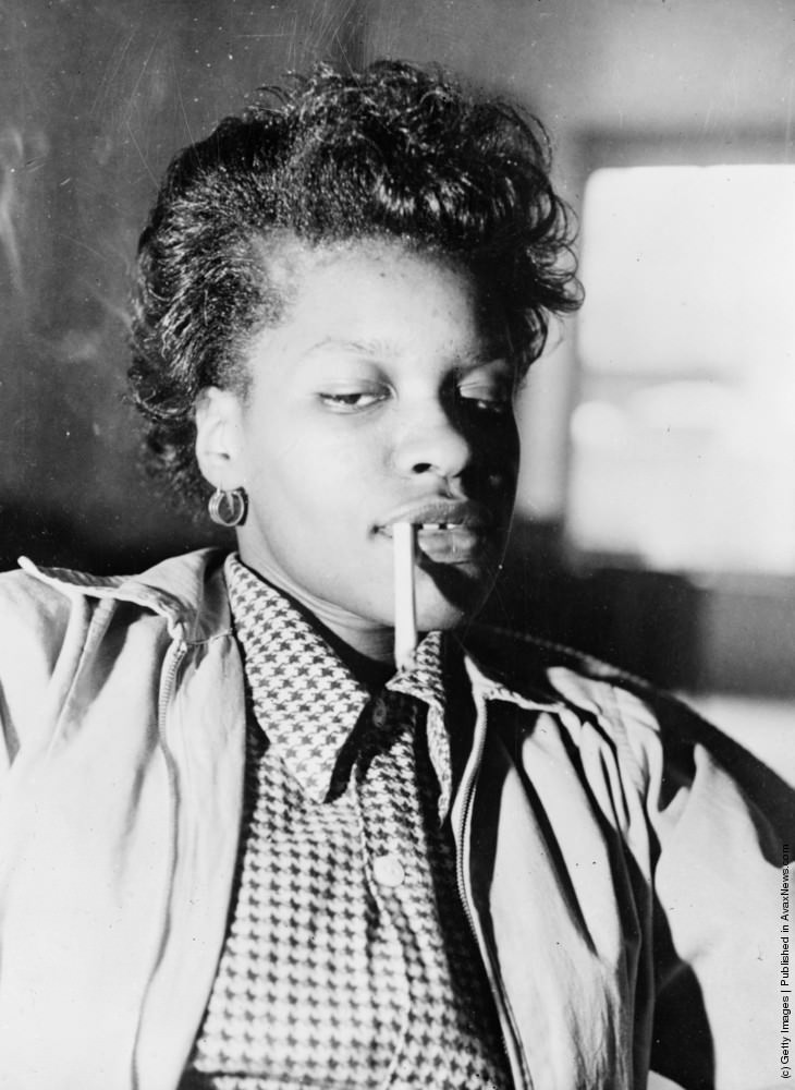 A teenage girl smoking a marijuana “reefer” in New York. June 1953.