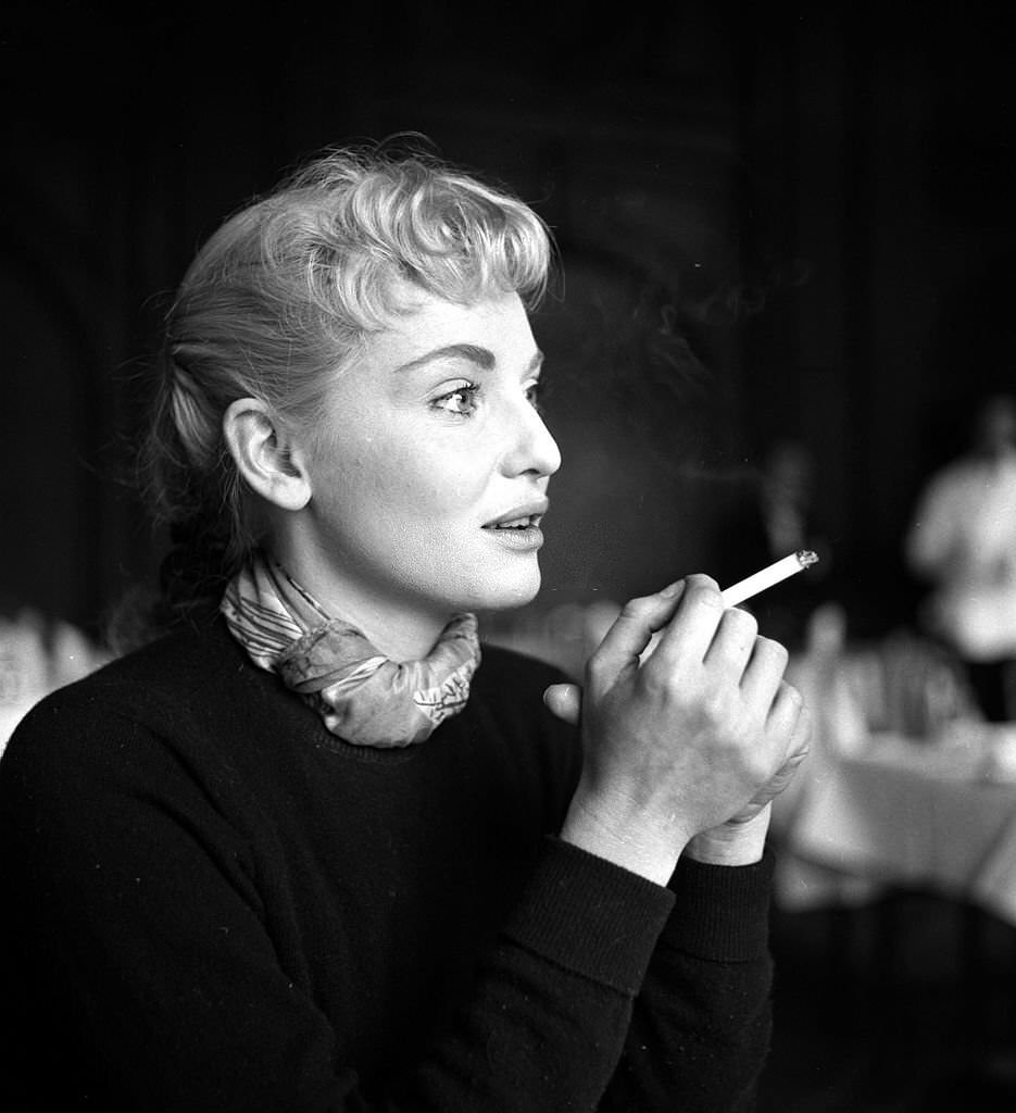Australian actress Diane Cilento smoking a cigarette in England, 1954.