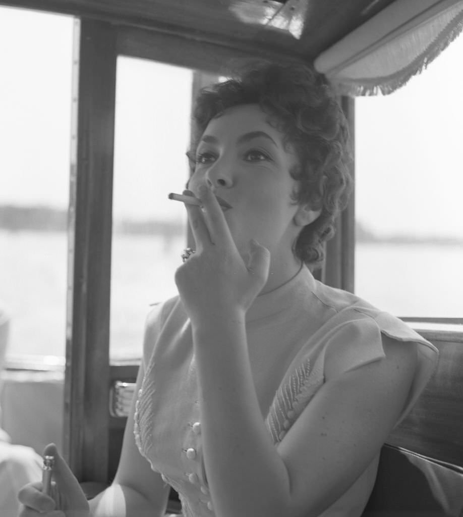 Italian actress Gina Lollobrigida smoking a cigarette in Venice, 1954.