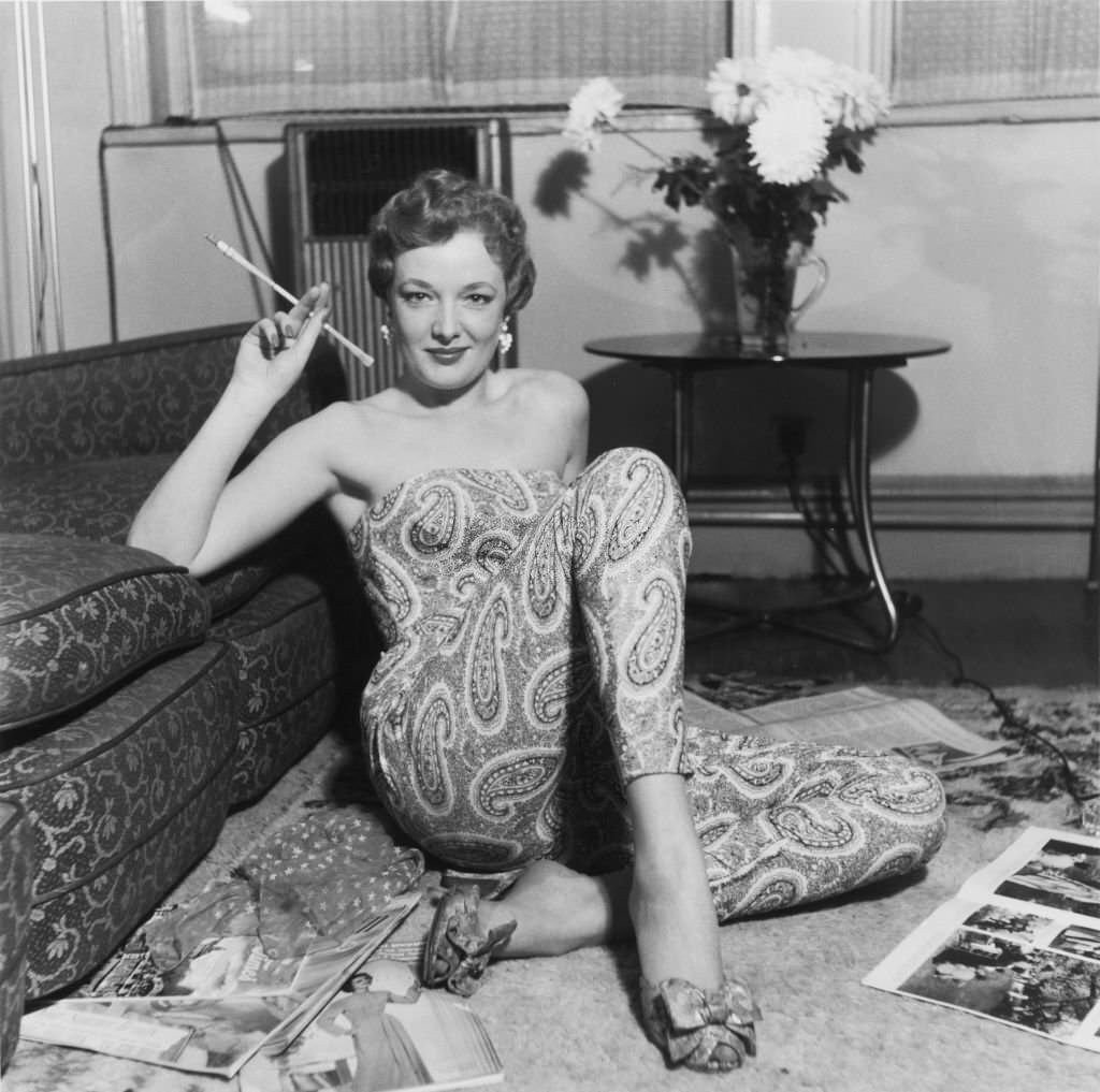 A model wearing a paisley-patterned jumpsuit at Mae McDowell's modeling school in Manchester, 1954.