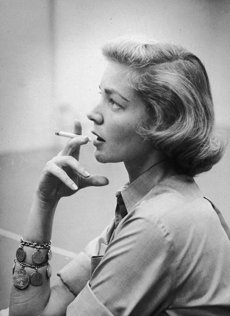 American actress Lauren Bacall smoking a cigarette during a rehearsal break in Hollywood, California, circa 1955.