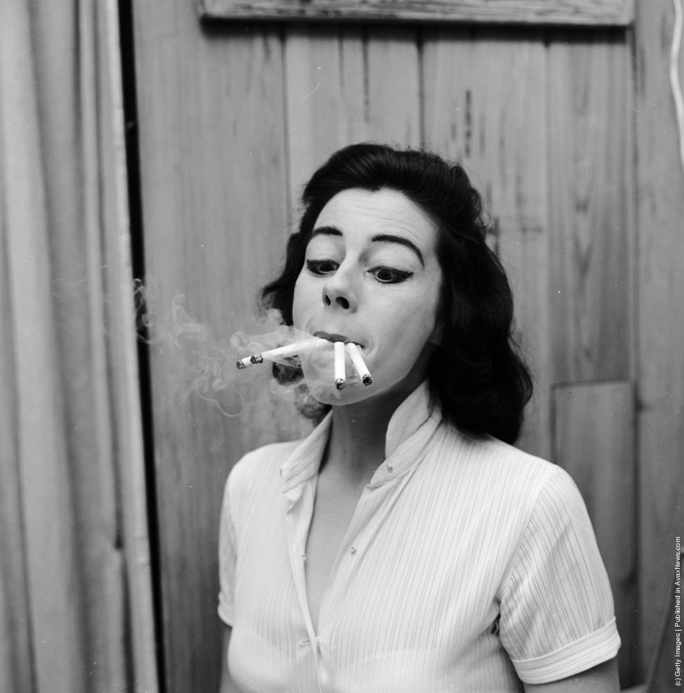 Smoking four cigarettes at once. From a series of images parodying women's lifestyle and beauty magazines, 1955.