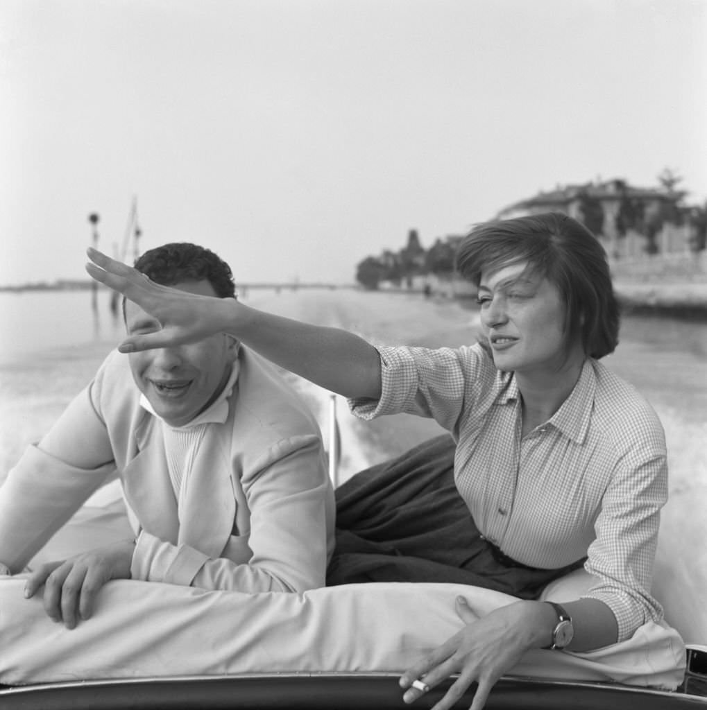 French actress Anouk Aimee smoking a cigarette with her husband Alexandre Astruc in Venice, 1955.