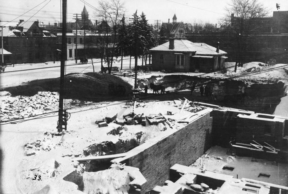 Construction of Denver Public Library halted by snow, Civic Center and Engine House Number One in background, 1900s