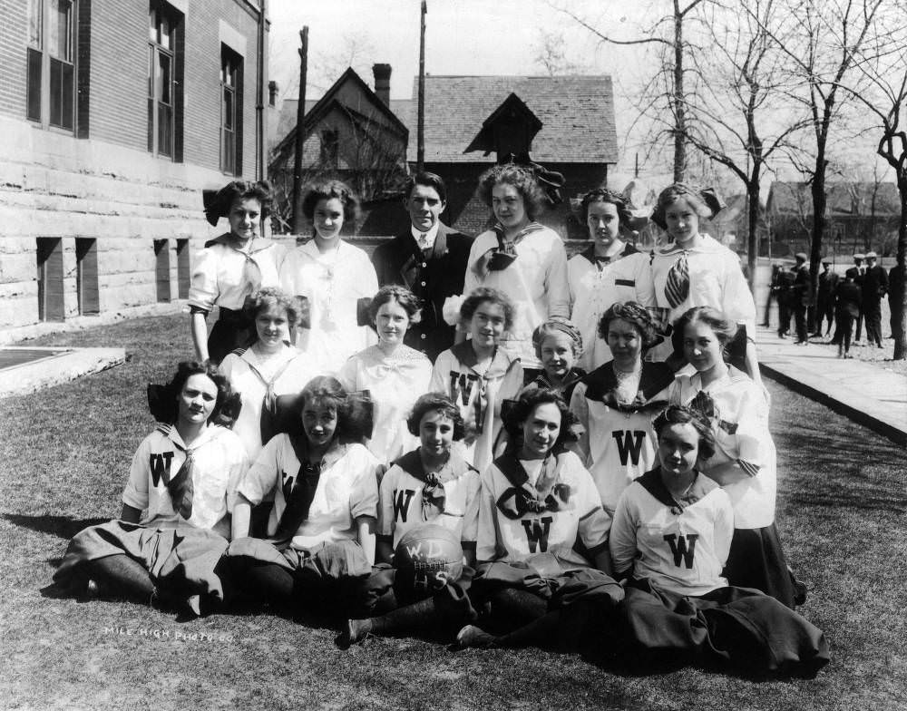 West Denver High School women's basketball team with their coach, featuring 'W' on their uniforms, 1908.