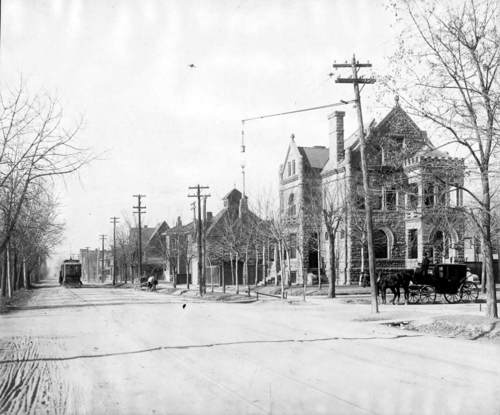 Victorian house at 1st Avenue and Grant Street, featuring Denver Tramway trolley and horse-drawn coach, 1905.