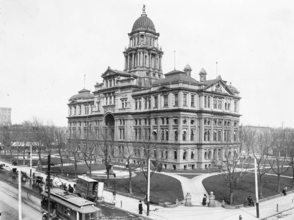 Denver County Courthouse at 15th and Tremont Street, featuring pedestrians and a street car, 1902