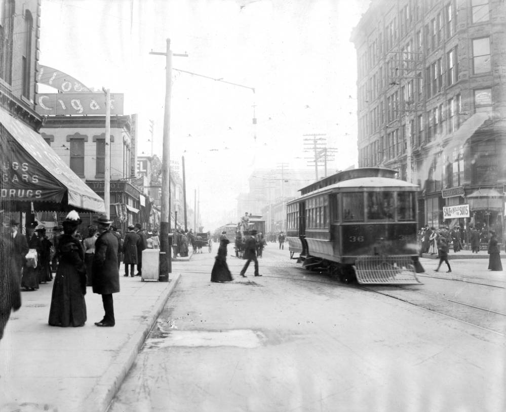 Trolleys number 36 and 333 on 15th Street, featuring various business signs and pedestrians, 1905.