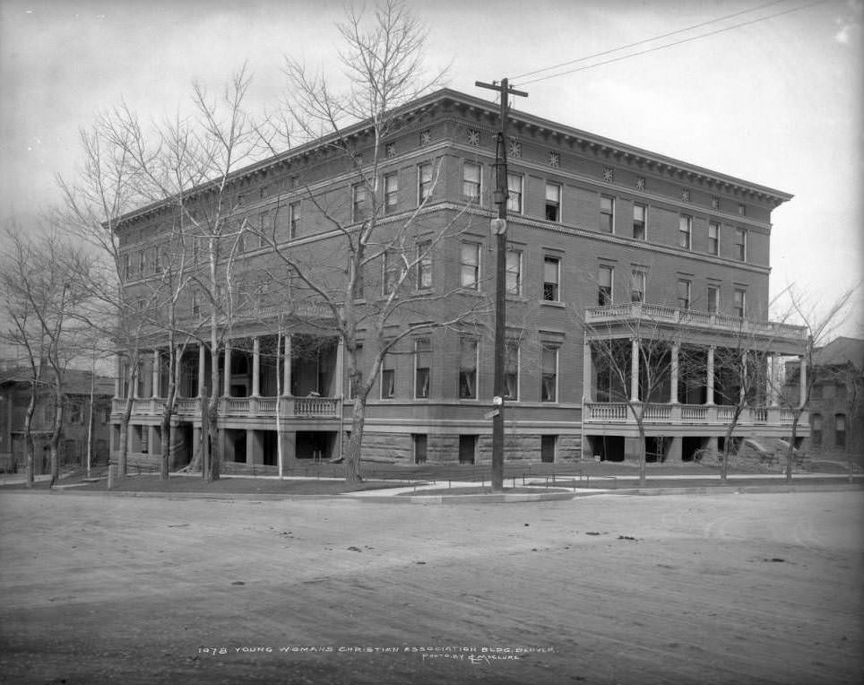 Exterior of Young Women's Christian Association building in Denver, adjacent to brick residences, built in 1899 and demolished in 1971