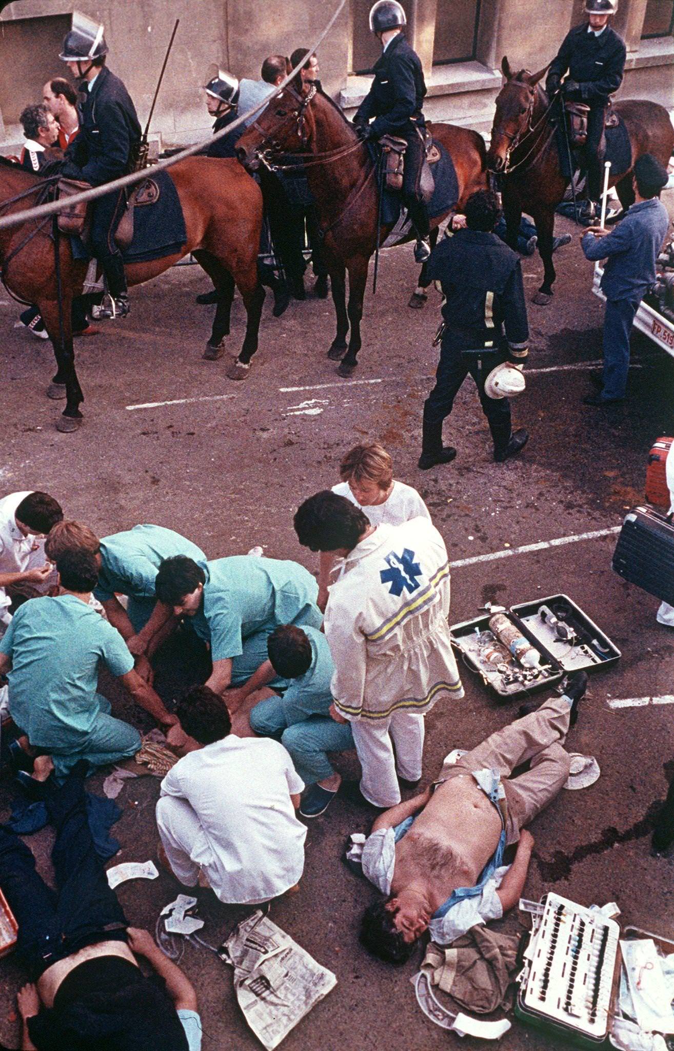 Rescuers attend victims after Heysel Stadium disaster, European Cup Final, 1985.
