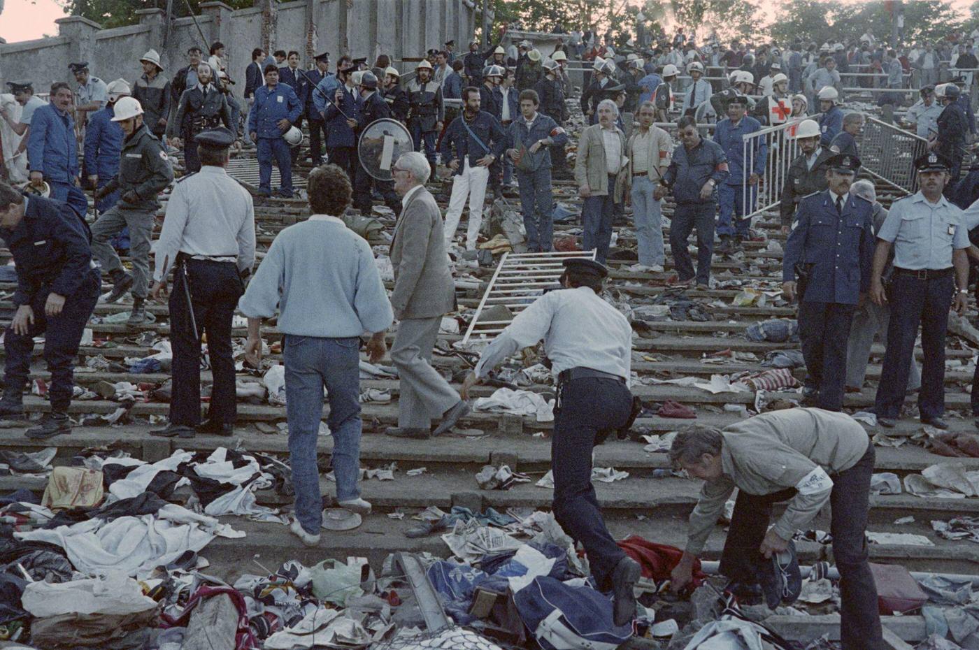 Rescuers and police search for victims after Heysel Stadium disaster, European Cup Final, 1985.