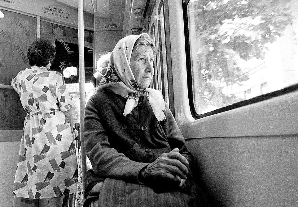 Public Transport: A woman looks wistfully out of a window while passing through Kyiv, 1999.