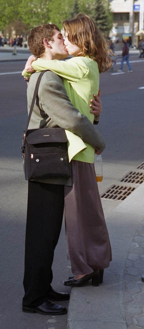 Roadside Romance: Young couple shares a kiss at the side of the road