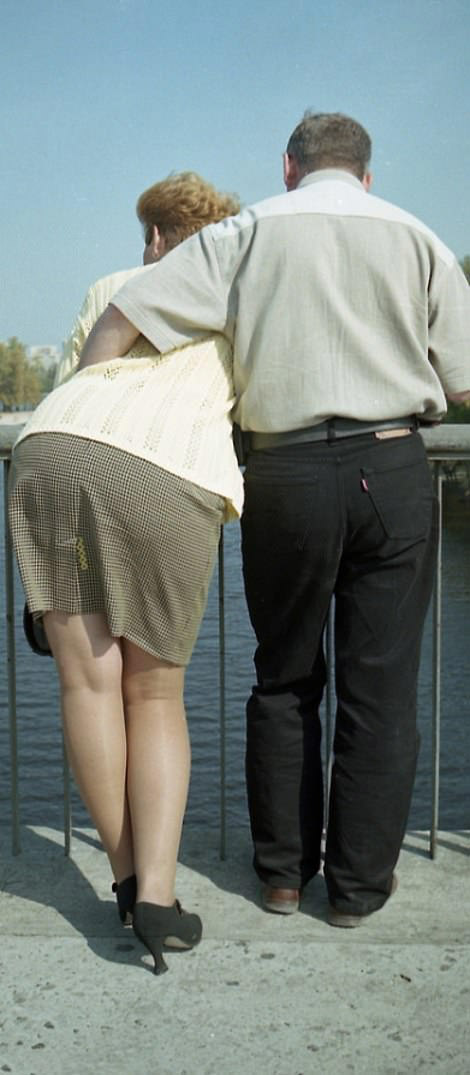 River Romance: Woman leans for a more comfortable embrace overlooking the river, 1999.