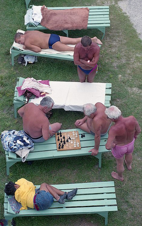 Chess at the Pool: Men in swim shorts pause for a game of chess, 1998.