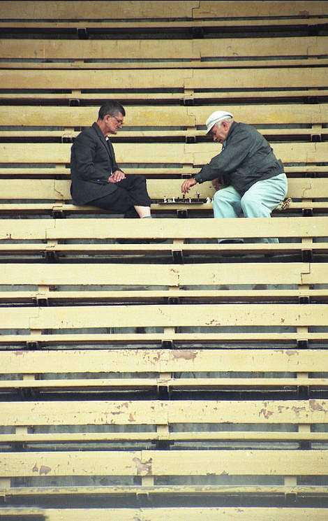 Stadium Chess: Two men play chess after the football stands empty, 1999.