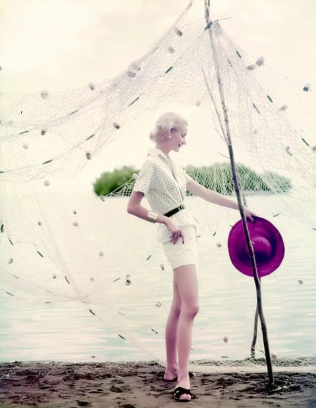 Sunny Harnett in a polka-dot blouse paired with white shorts and a black belt, 1954.