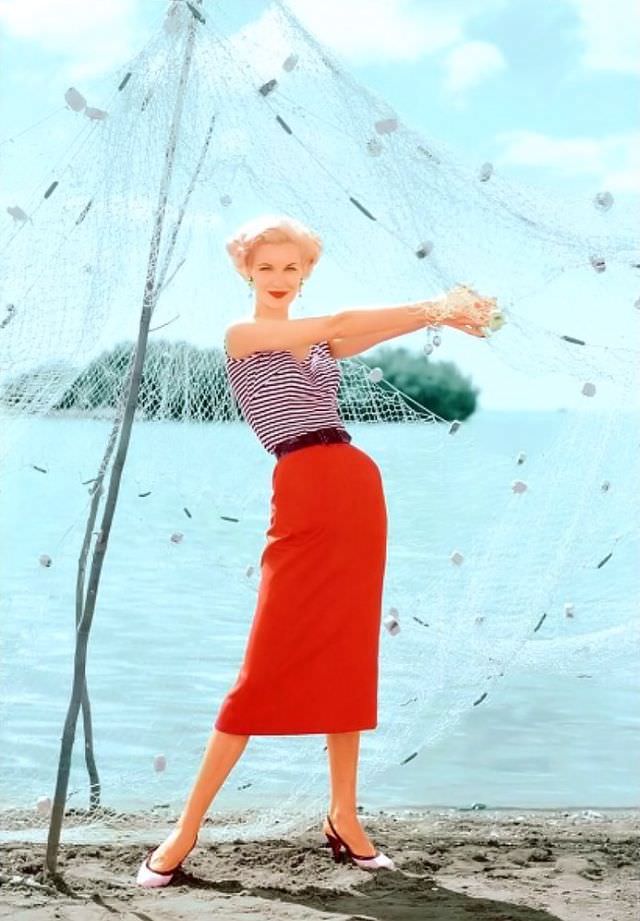 Sunny Harnett in a black and white striped top paired with a slim red skirt, in Puerto Rico, 1954.