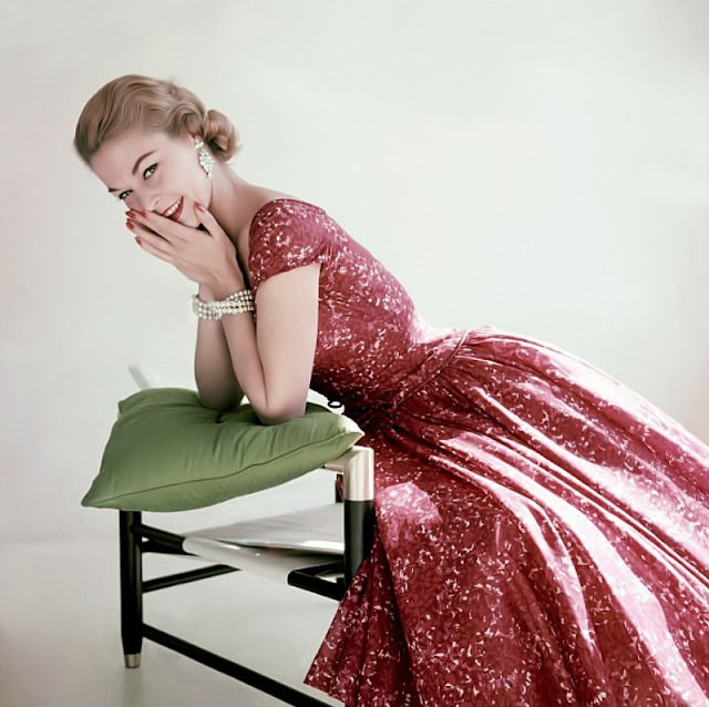 Jean Patchett in a red and pink floral print cotton chiffon dress by Adele Simpson, 1955.