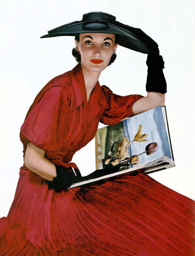 Evelyn Tripp in a red and black printed silk surah dress by Christian Dior, paired with a large black milan straw hat, 1954.