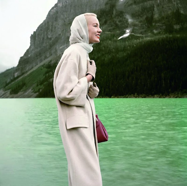 Mrs. William McManus, Vogue's young fashion editor, wears a pale cashmere coat at Lake Louise, Banff National Park, 1955.