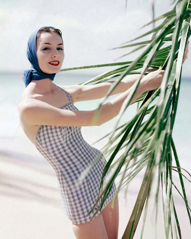 Lucinda Hollingsworth in a lastex swimsuit by Catalina, complemented by a scarf by Echo, 1956.