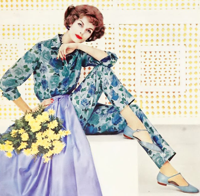 Anne St. Marie wears a sheer shirt and rose-print slacks with a blue over skirt, 1958.