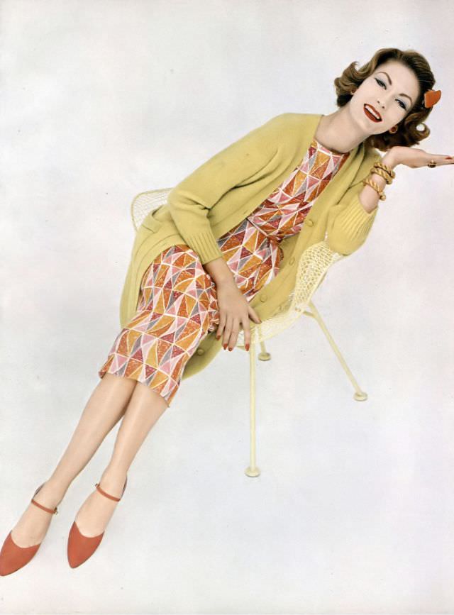 Mary McLaughlin in a colorful diamond print dress with a lime-colored sweater coat, both by Greta Plattry, 1958.