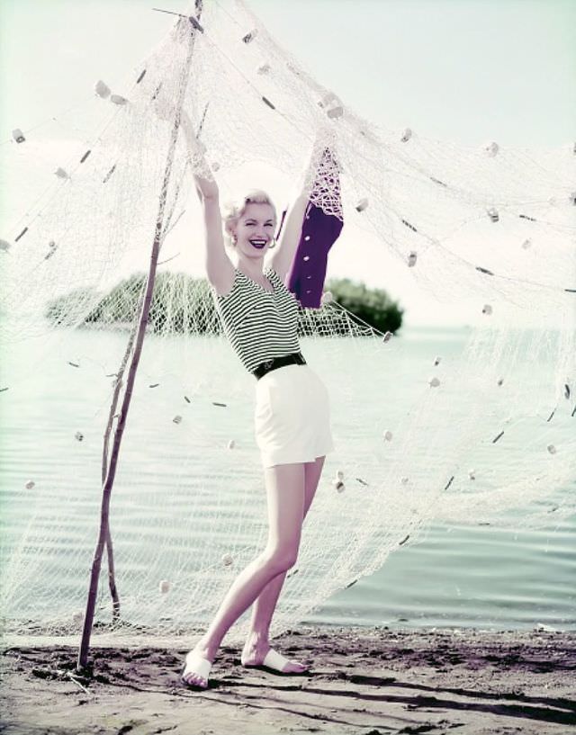 Sunny Harnett in a black and white striped tank, black belt, and white shorts, in Puerto Rico, 1954.