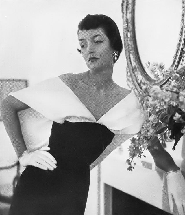 Maxime de la Falaise in a black dinner dress with a large white linen collar by Schiaparelli, 1949.