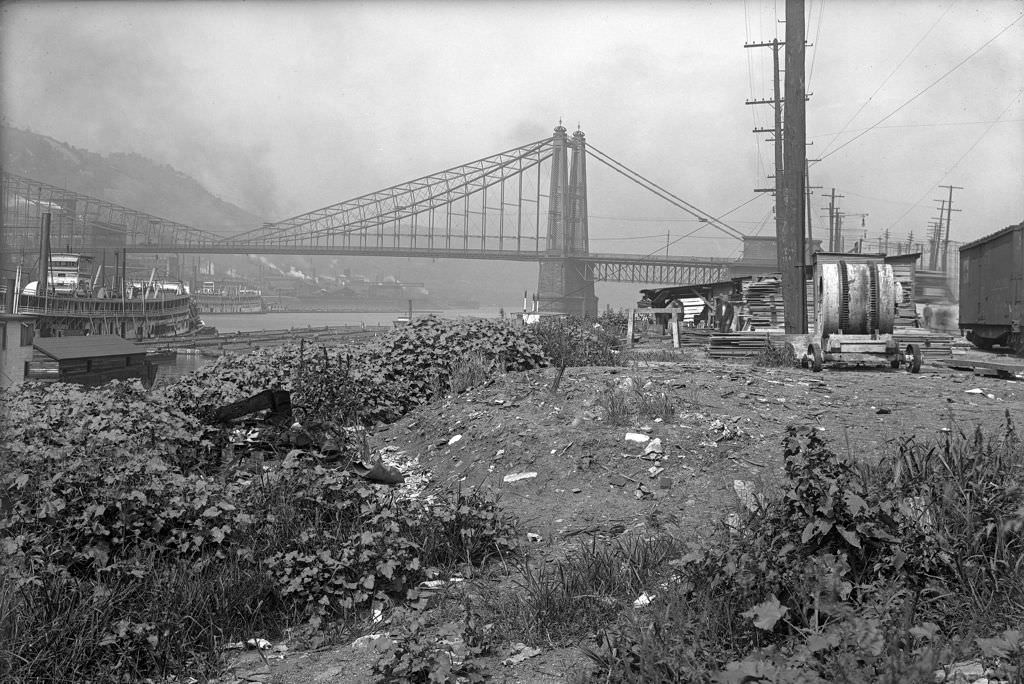 Riverside Scene with bridge and riverboats, 1910s