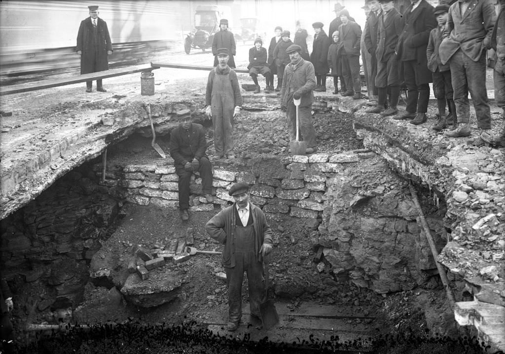 Men working on break, washout visible, 1920.