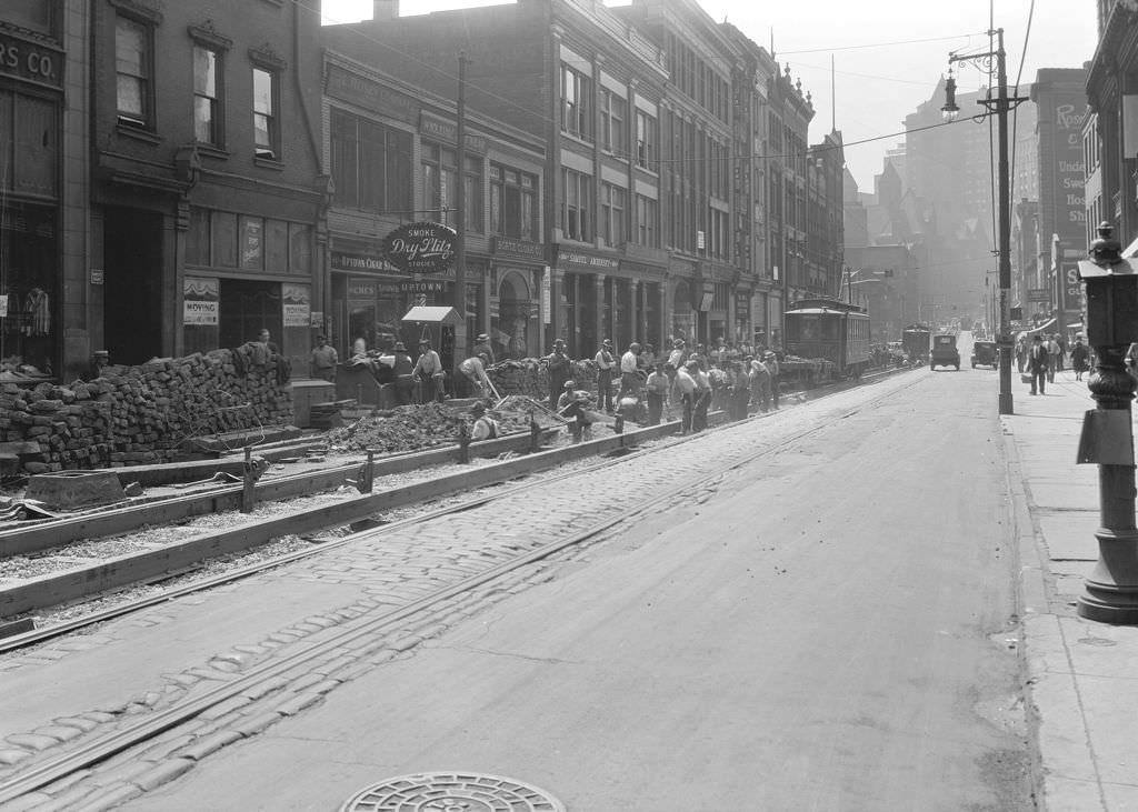 Fifth Avenue construction from Hooper Street, shows Uptown Cigar and more, 1930