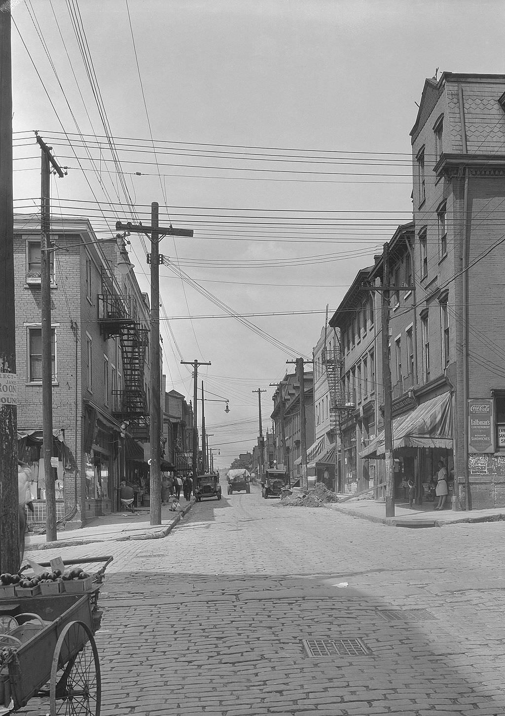 Logan Street from Epiphany, Laibman's Confectionery on right, 1931