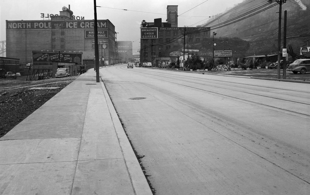 West Carson Street looking east from opposite McFarlins Grill near the Duquesne Incline showing North Pole Ice Cream Company and Breakfast Cheer Coffee, 1940