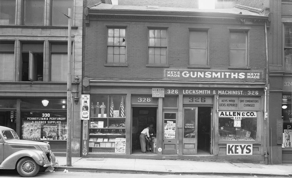 Third Avenue looking south showing flags and Pennsylvania Perfumery and Barber Supplies, 1942