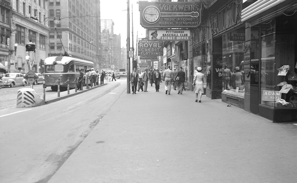 Sidewalk at Volkwein's Music Store looking northeast showing signs for Volkwein's and the Pittsburgh Baseball Club ticket office, 1943